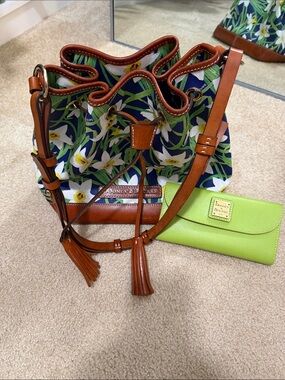 Dooney & Bourke Navy Floral Drawstring Bucket Bag with Brown Leather Trim.